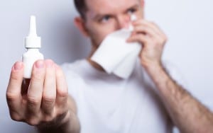 Ill man holds nose drops